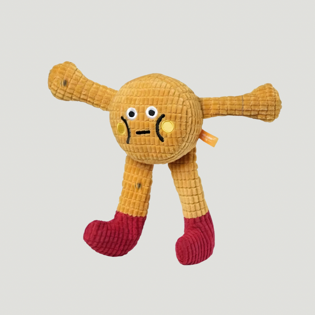 Yellow plush toy with a face on a light gray background